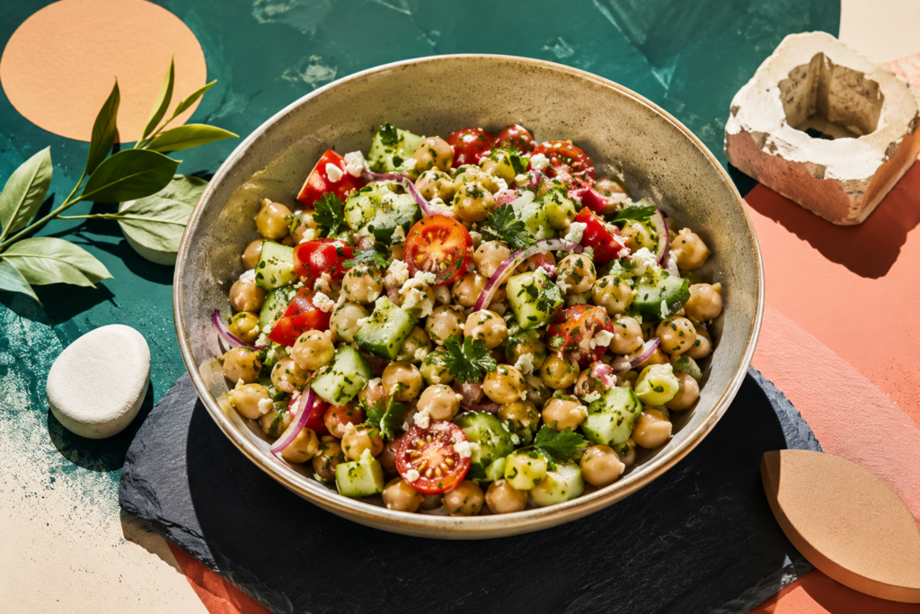 A fresh bowl of crunchy chickpea and Mediterranean cucumber salad showcasing healthy ingredients for fiber-rich summer recipes